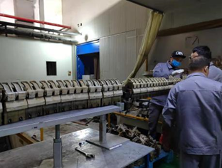 Technicians working at a chain refurbishment station